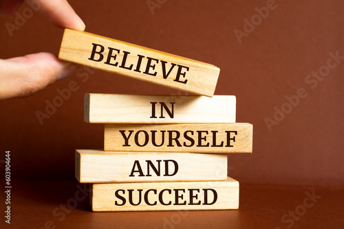 Wooden blocks with words 'Believe in yourself and succeed'. Motivation Quote