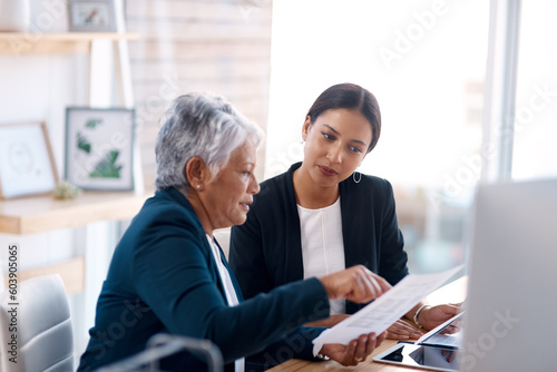 Mentor, training or business women with documents talking, speaking or planning project in office. Paperwork, teamwork collaboration or senior manager reading with intern for administration coaching