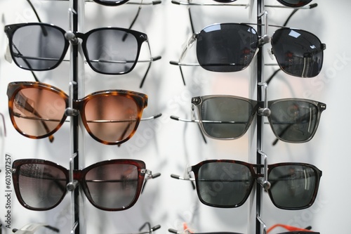 Stand with sunglasses. Sale the city market or in the store sunglasses. Trendy sunglasses, Summer eyeglasses, fashion collection, Different sunglasses on a stand