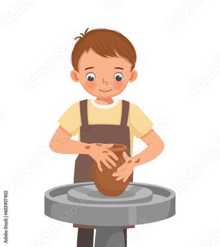 Cute little boy  making ceramic pot on pottery wheel in a workshop 