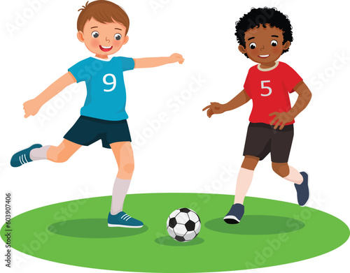 Cute kids playing soccer football together in the field