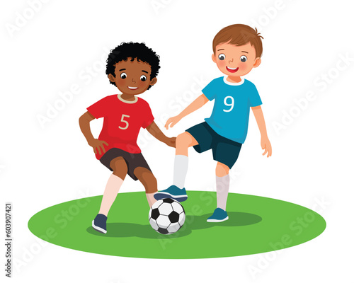 Happy kids playing soccer football together in the field