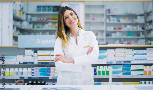 Pharmacy portrait, arms crossed and happy woman, pharmacist or manager in drugs store, dispensary or shop. Hospital dispensary, medicine product shelf and person confident in retail clinic service photo