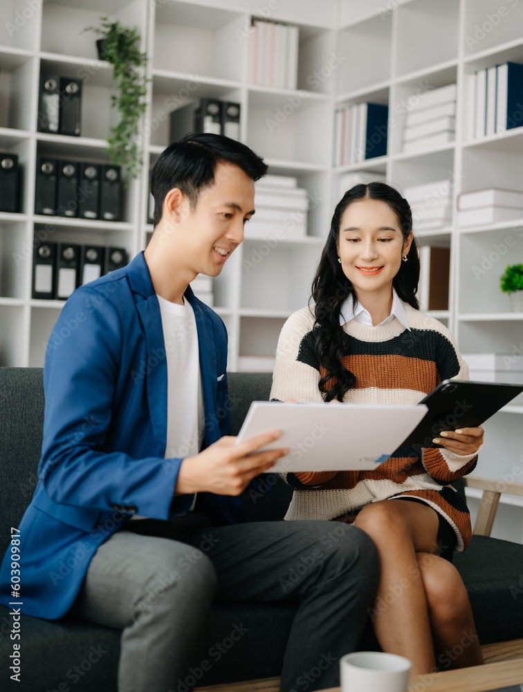 Two business workers talking on the smartphone and using laptop at the home office. Two business workers talking on the smartphone and using laptop at the home office.