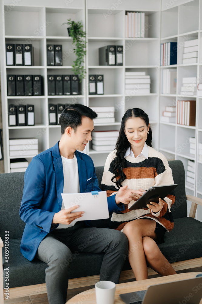 Two business workers talking on the smartphone and using laptop at the home office. Two business workers talking on the smartphone and using laptop at the home office.