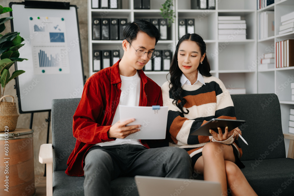 Businesswomen work and discuss their business plans. A Human employee explains and shows her colleague the results paper in modern office.. Businesswomen work and discuss their business plans. A Human employee explains and shows her colleague the results paper in modern office..