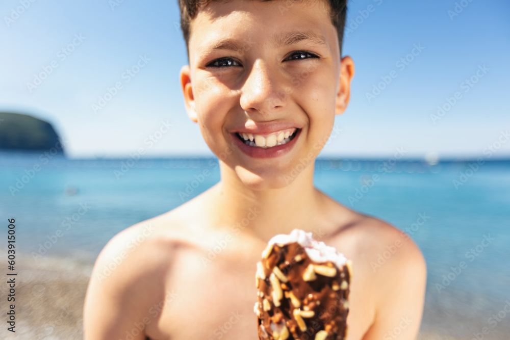 Cute boy eating ice cream on the beach on vacation Cute boy eating ice cream on the beach on vacation