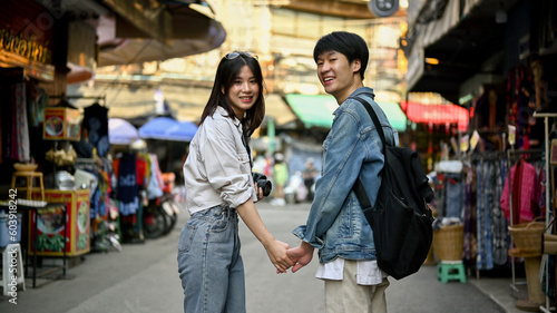 A tourist couple holding hands while sightseeing the Chiang Mai old town