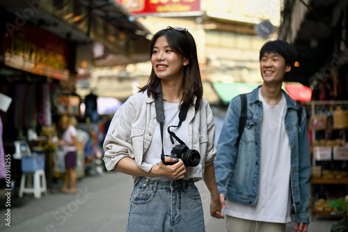 A female enjoys taking photos and sightseeing the old town market with her boyfriend