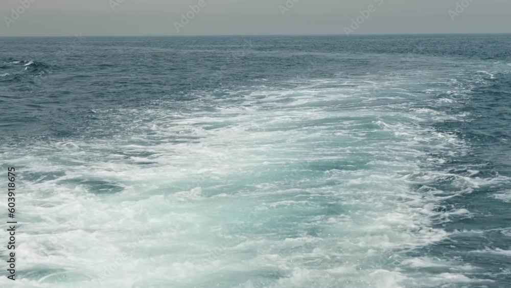 Waves and wake of a private boat sailing on the sea on a cloudless day. Waves and wake of a private boat sailing on the sea on a cloudless day.