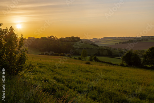 Golden hour during sunrise over the rolling hills of the Dutch province of Limburg near the village of Fromberg  English  Fromberg   a typical region for agricultural activities