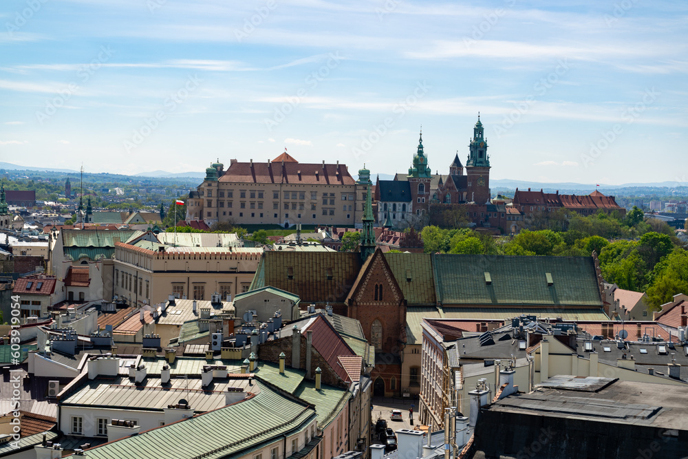 Fototapeta premium Aerial view of Kraków, Poland. Tenement houses of Cracow old town center district, with view of Wawel Hill Royal Castle complex. Krakow urban architecture. 