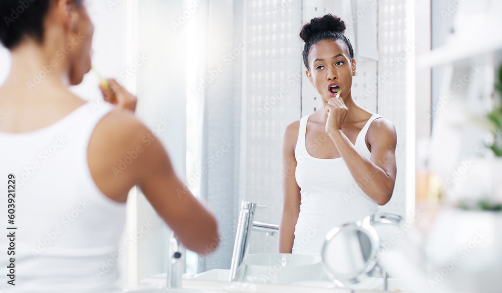 Woman brushing teeth in bathroom, mirror with dental and oral hygiene with morning routine, toothbrush and health. Female person at home, grooming and self care with clean mouth and wellness