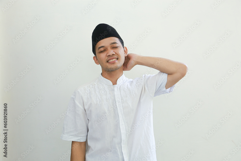 Unhappy young Asian Muslim man feeling very upset, crying, rubs her tears and looks at the camera isolated on white background. People religious Islamic lifestyle concept Unhappy young Asian Muslim man feeling very upset, crying, rubs her tears and looks at the camera isolated on white background. People religious Islamic lifestyle concept