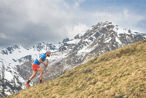 A sporty man tackles a steep mountain climb