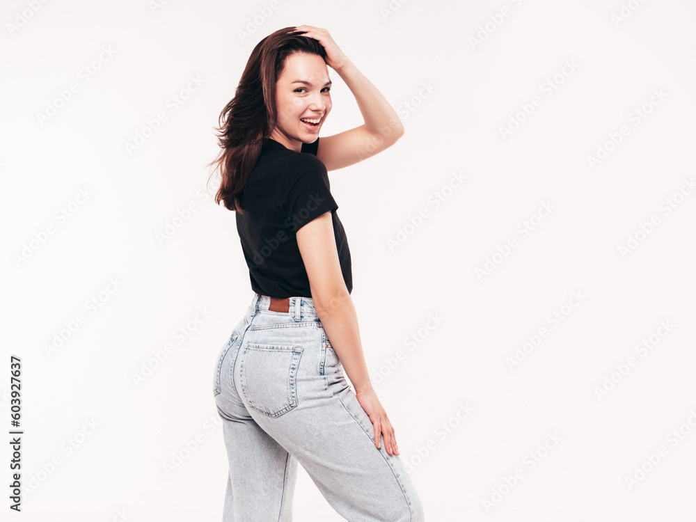 Young beautiful woman. Trendy carefree model in casual summer black T-shirt and blue jeans. Positive female isolated on white in studio. Cheerful and happy. Copy space, mockup Young beautiful woman. Trendy carefree model in casual summer black T-shirt and blue jeans. Positive female isolated on white in studio. Cheerful and happy. Copy space, mockup
