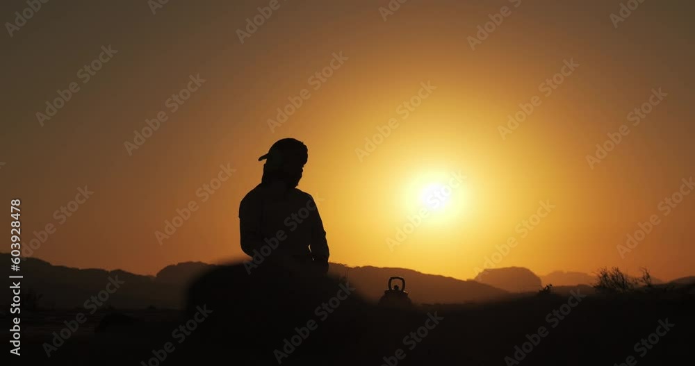 Silhouette of an arab man at sunset in the desert Silhouette of an arab man at sunset in the desert