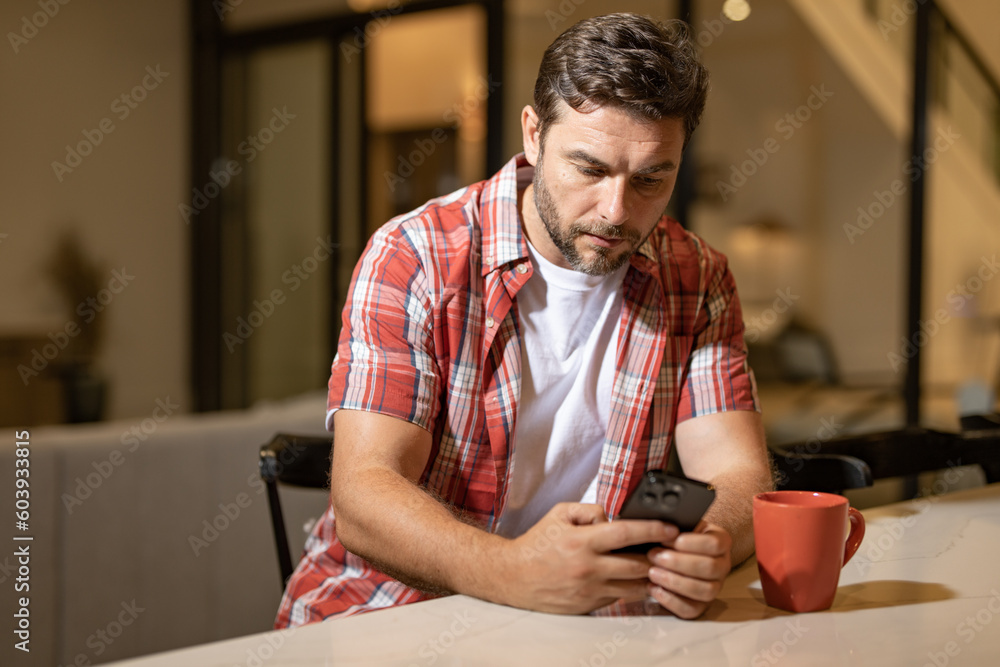 Man relaxing sitting on couch while looking at mobile phone. Mature man using smartphone to checking email at home. Man reading news on smartphone. Man talking on mobile phone. Man relaxing sitting on couch while looking at mobile phone. Mature man using smartphone to checking email at home. Man reading news on smartphone. Man talking on mobile phone.