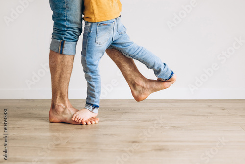 Happy father and son playing at home nad having fun. Concept of friendly family