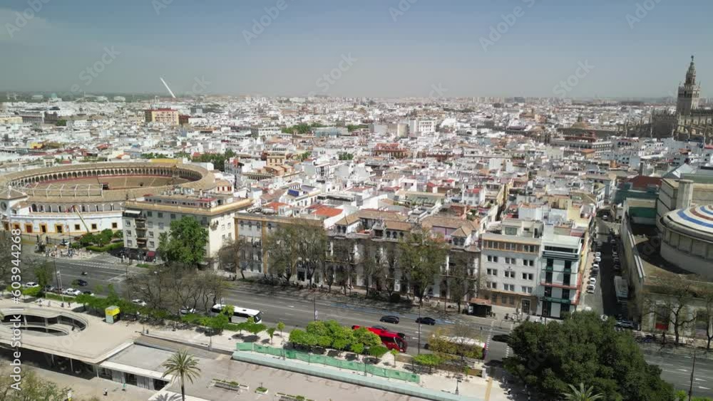 Panning drone clip of cityscape of Seville, Spain showing church spire and stadium buildings Panning drone clip of cityscape of Seville, Spain showing church spire and stadium buildings