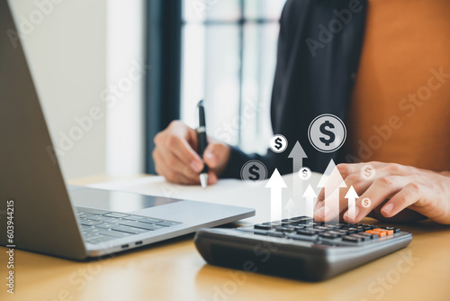 Financial, business growth concept, Businessman using calculator and writing make note with calculating financial expense.