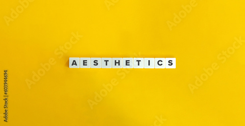 Aesthetics Word. Block Letter Tiles on Yellow Background.