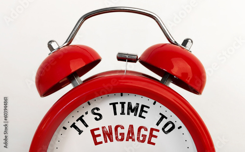 Red alarm clock with text Time to engage