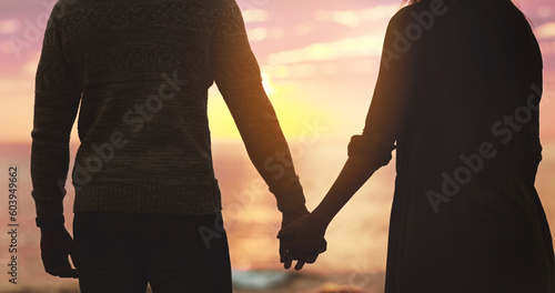 Couple, holding hands and sunset beach sky with love on vacation, holiday or adventure. Silhouette of man and woman together for freedom, marriage and travel journey or commitment outdoor in nature