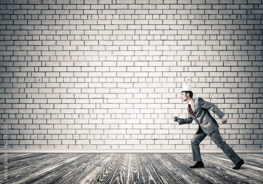 King businessman in elegant suit running in empty room King businessman in elegant suit running in empty room