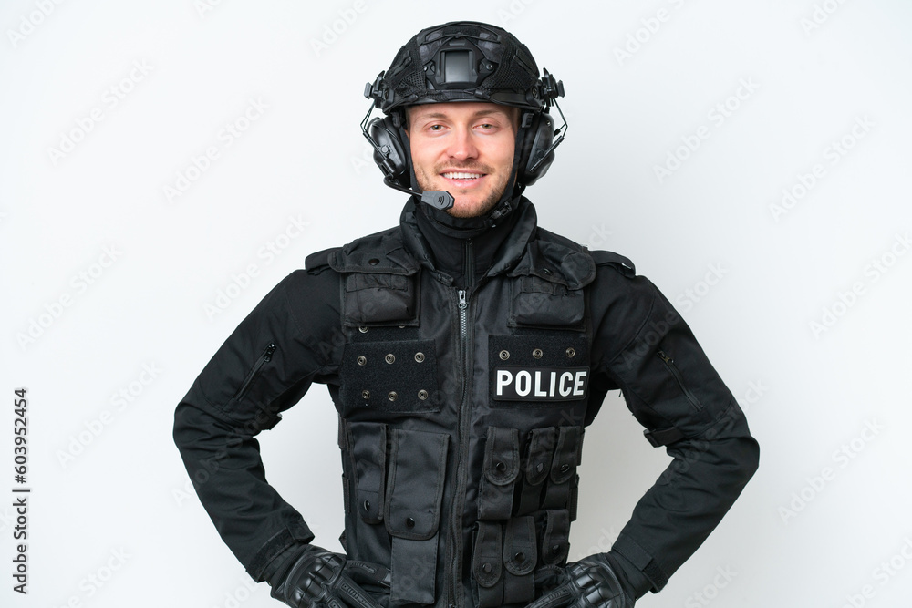 SWAT man over isolated white background posing with arms at hip and smiling SWAT man over isolated white background posing with arms at hip and smiling