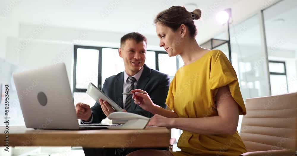 Business people talking using a digital tablet and sitting at office table. Team looking at touchpad screen of technological device are discussing startup Business people talking using a digital tablet and sitting at office table. Team looking at touchpad screen of technological device are discussing startup