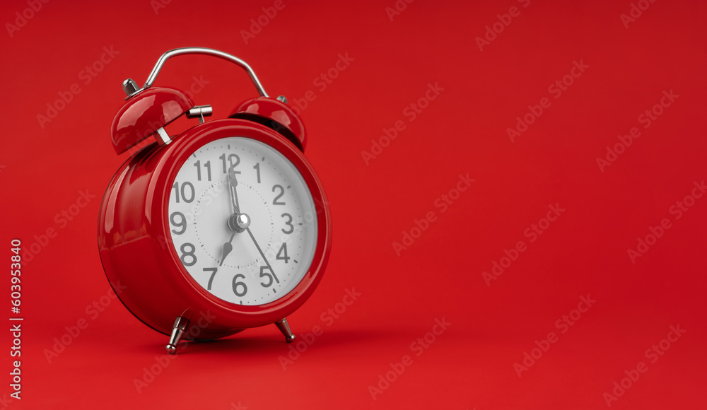 Red alarm clock on a red background. Red alarm clock on a red background.