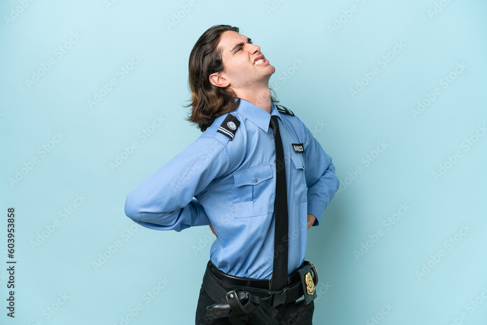 Young police caucasian man isolated on blue background suffering from backache for having made an effort Young police caucasian man isolated on blue background suffering from backache for having made an effort