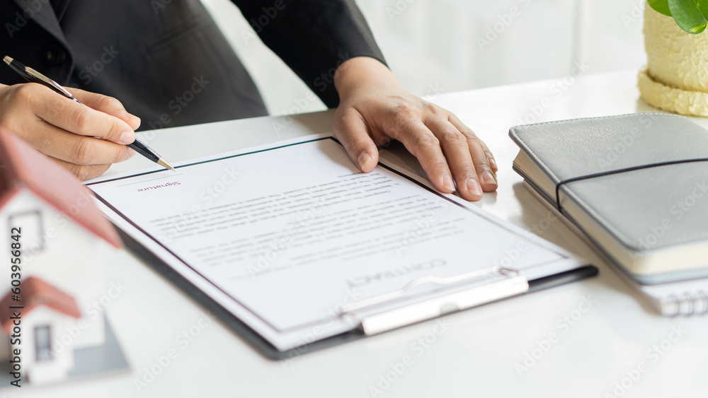 Accountant, lawyer who works in the field of financial investment in the office. Protective Insurance delivers home for protection and care real estate sales concept. Accountant, lawyer who works in the field of financial investment in the office. Protective Insurance delivers home for protection and care real estate sales concept.
