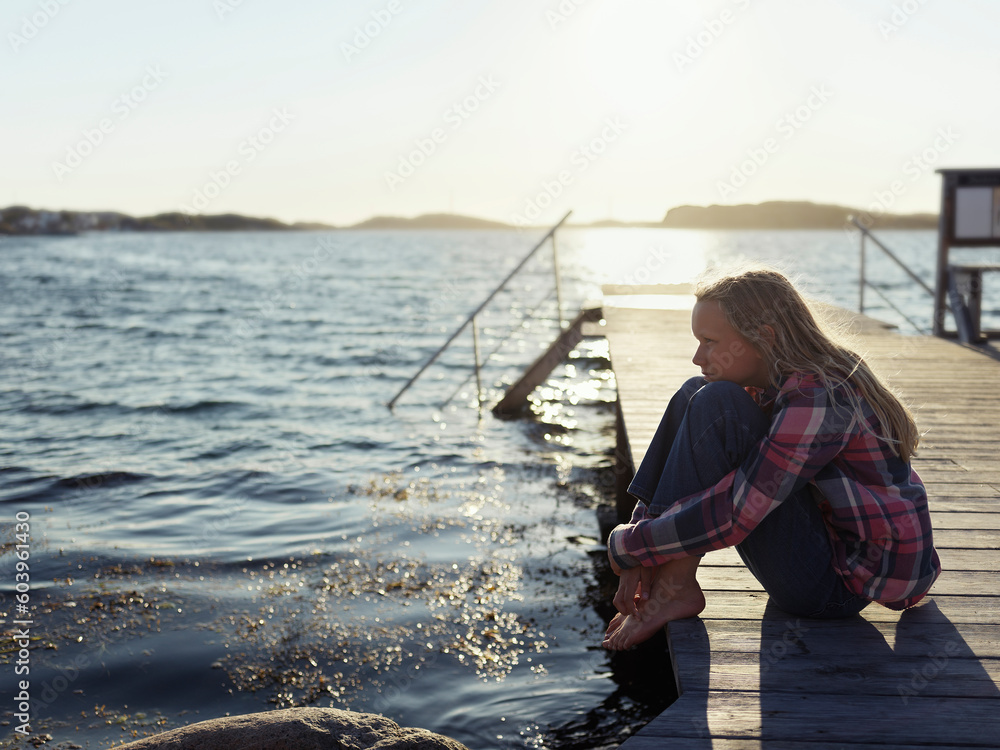 Girl sitting on jetty during sunset Girl sitting on jetty during sunset