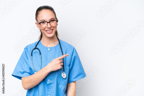 Young caucasian surgeon doctor woman isolated on white background pointing to the side to present a product