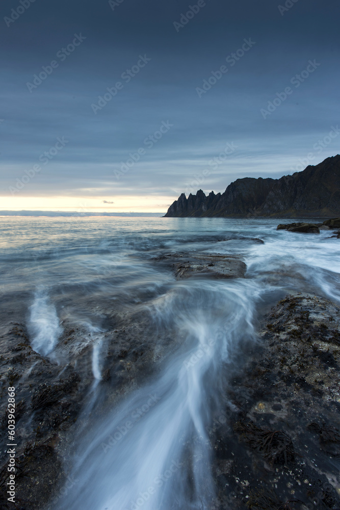Long exposure of waves on beach under clouds Long exposure of waves on beach under clouds