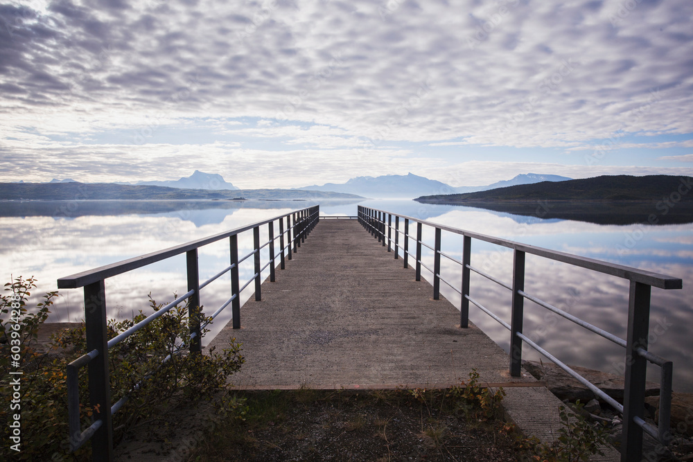 Jetty on lake under clouds Jetty on lake under clouds