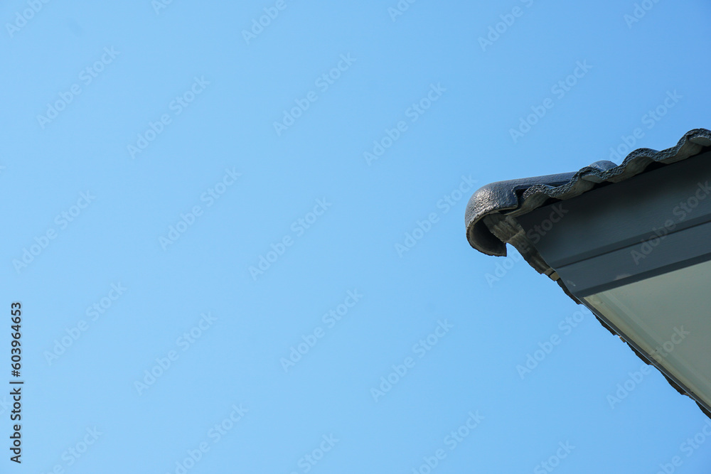 focus on part of roof and structure of modern house style with blue sky in sunshine day. Tiles and space under roof problem about bird make a nest. Engineering, architecture and design home. focus on part of roof and structure of modern house style with blue sky in sunshine day. Tiles and space under roof problem about bird make a nest. Engineering, architecture and design home.
