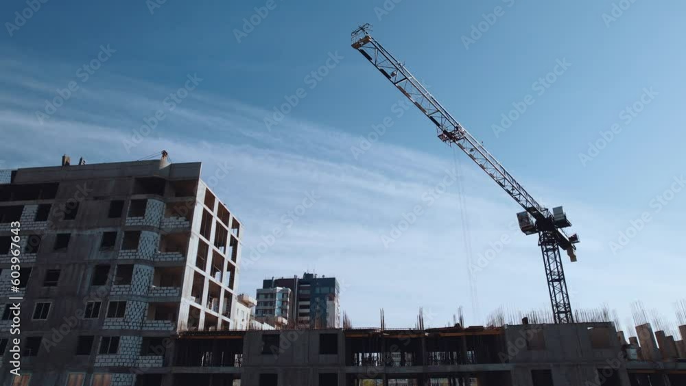 Aerial survey of the construction of a house, the work of tower cranes, the construction of a residential building Aerial survey of the construction of a house, the work of tower cranes, the construction of a residential building