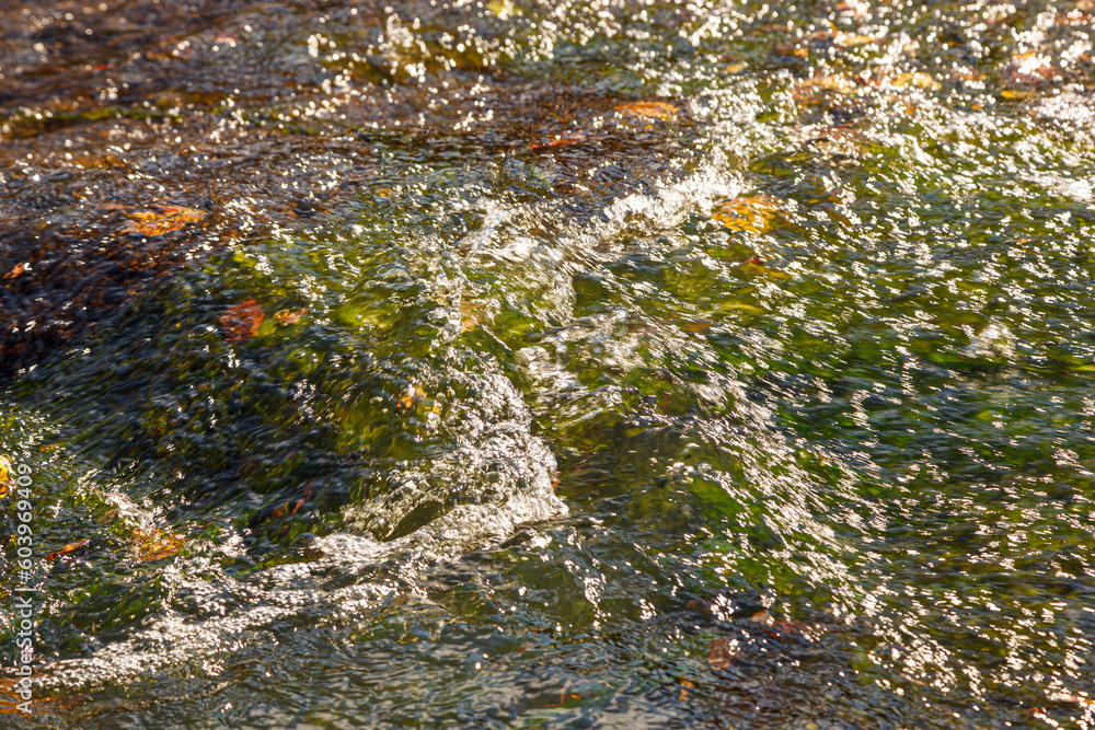 flow of water and spray from a stone flow of water and spray from a stone