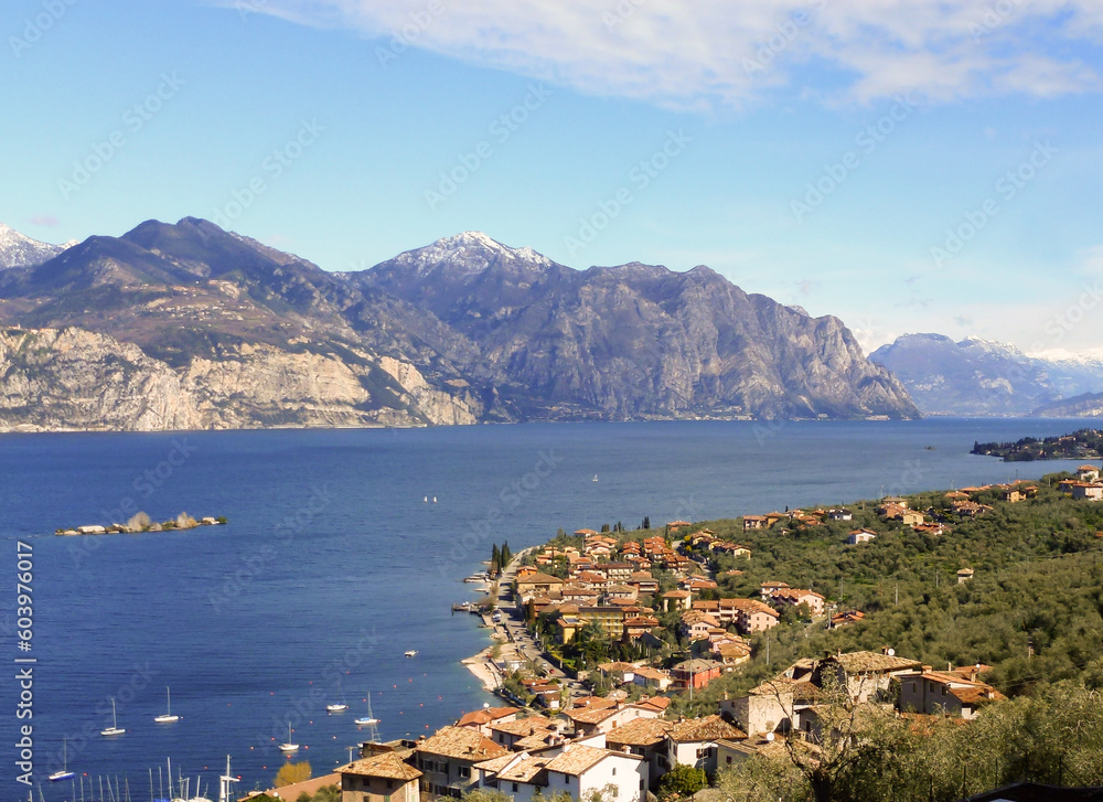 Panorama from the top of a small town on the shore of a sea bay and mountains in the far background
