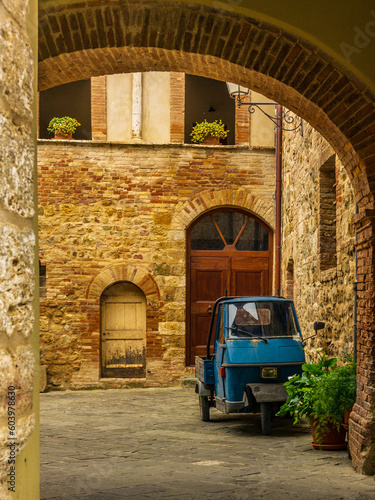 An old three-wheeler on the cobbled streets of San Quirico d'Orcia photo