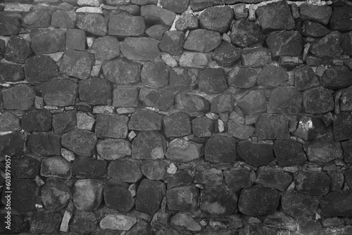 pattern gray color of historical style design decorative uneven real rock, stone wall surface with cements seam. Texture of a stone wall. Old castle stone wall texture background. front view backdrop
