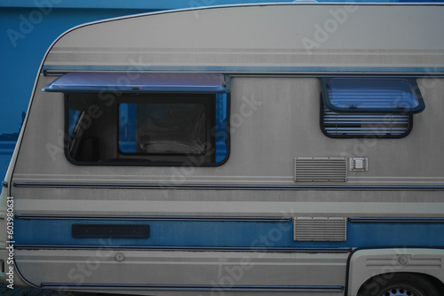 empty travel trailer (camper trailer, camper van, caravan). Side view. open windows. no people. white and blue RV Trailer Journey. blinds for opened windows.