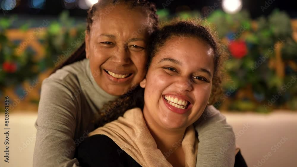 Happy african mother and adult daughters having tender moment in front of camera outdoor
Happy african mother and adult daughters having tender moment in front of camera outdoor