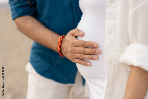 pregnant couple, dad feeling the baby bump, maternity shoot © Rishita