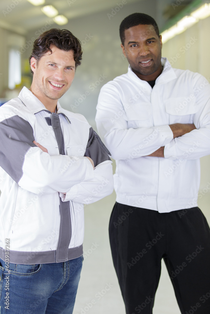portrait of two workers looking at camera portrait of two workers looking at camera