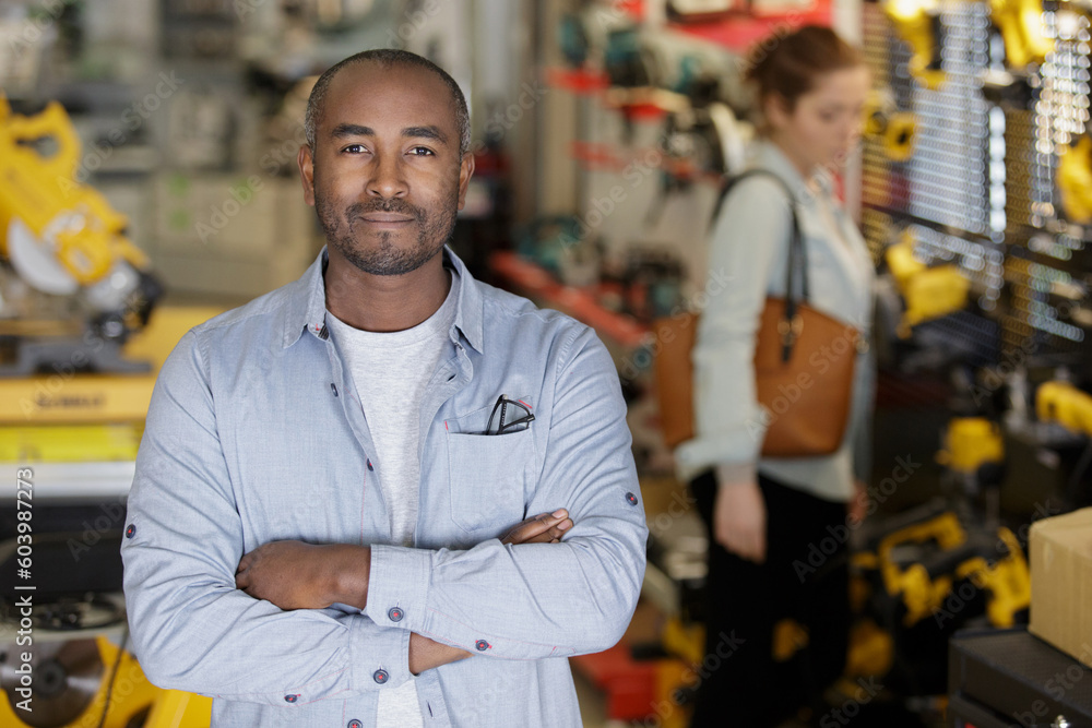 man hardware store seller arms crossed man hardware store seller arms crossed