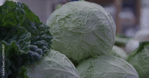 
cabbages in basket inside a village market